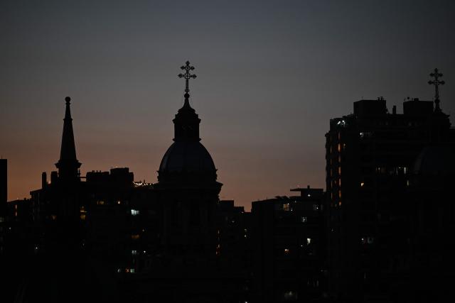 The Santiago Cathedral is pictured at sunset in Santiago on November 15, 2025. Chile will hold presidential elections on November 16, 2025. (Photo by Marvin RECINOS / AFP)