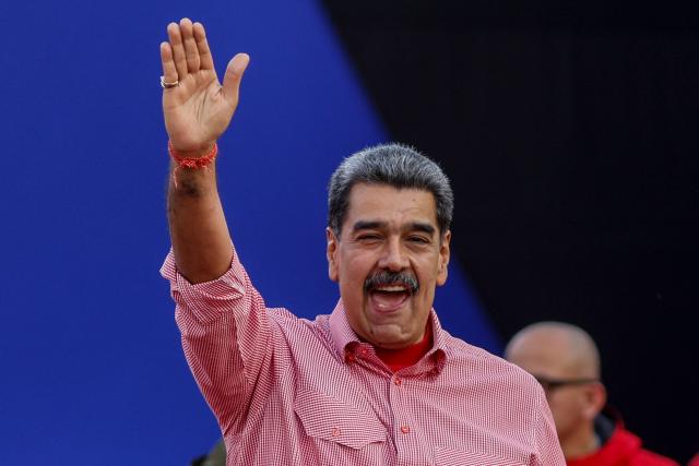 Venezuela's President Nicolas Maduro waves to supporters during a demonstration for the swearing-in of Bolivarian committees in Caracas on November 15, 2025. (Photo by AFP)