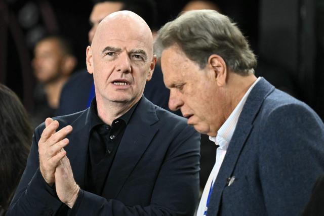 President of the Colombian Football Federation Ramon Jesuru (R) and FIFA President Gianni Infantino speak as they attend the international friendly football match between Colombia and New Zealand at Chase Stadium in Fort Lauderdale, Florida, on November 15, 2025. (Photo by Chandan Khanna / AFP)