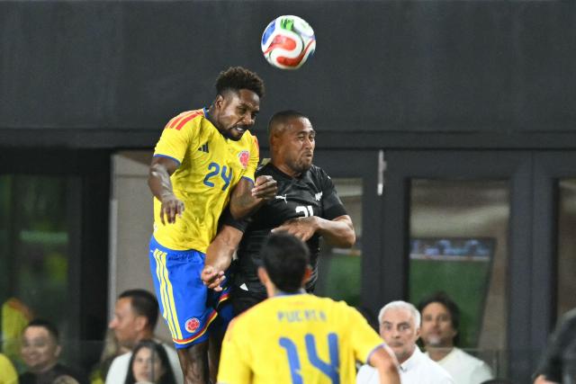 New Zealand's defender #21 Bill Tuiloma (R) and Colombia's defender #24 Alvaro Angulo jump for the ball during the international friendly football match between Colombia and New Zealand at Chase Stadium in Fort Lauderdale, Florida, on November 15, 2025. (Photo by CHANDAN KHANNA / AFP)
