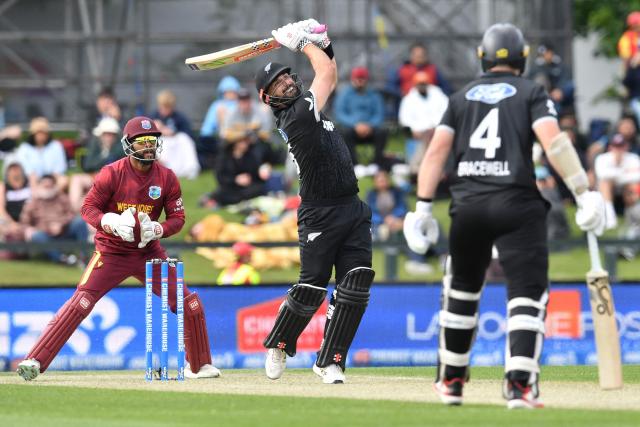 New Zealand's Daryl Mitchell (C) bats during the first one-day international cricket match between New Zealand and West Indies at Hagley Oval in Christchurch on November 16, 2025. (Photo by Sanka Vidanagama / AFP)