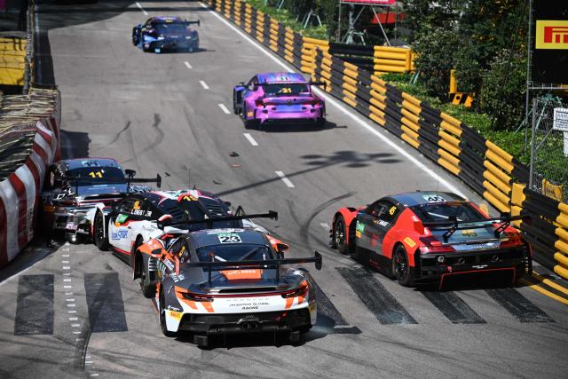 Schumacher CLRT Turkish team driver Ayhancan Guven (L) drives his Porsche 911 GT3 R (992) into the barrier as Team Absolute Corsa German driver Luca Engstler (C) and Phantom Global Racing French driver and Dorian Boccolacci (R) crash into him at the start of the FIA GT World Cup race during the 72nd Macau Grand Prix in Macau on November 16, 2025. (Photo by Peter PARKS / AFP)