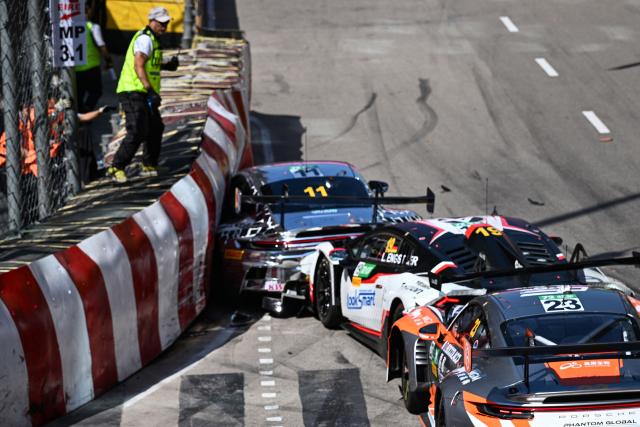 Schumacher CLRT Turkish team driver Ayhancan Guven (L) drives his Porsche 911 GT3 R (992) into the barrier as Team Absolute Corsa German driver Luca Engstler (C) and Phantom Global Racing French driver and Dorian Boccolacci (R) crash into him at the start of the FIA GT World Cup race during the 72nd Macau Grand Prix in Macau on November 16, 2025. (Photo by Peter PARKS / AFP)