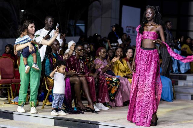 A model walks the catwalk during The Gambia International Fashion Week at Sir Dawda Kairaba Jawara International Conference Centre in Banjul on November 15, 2025. (Photo by Muhamadou BITTAYE / AFP)