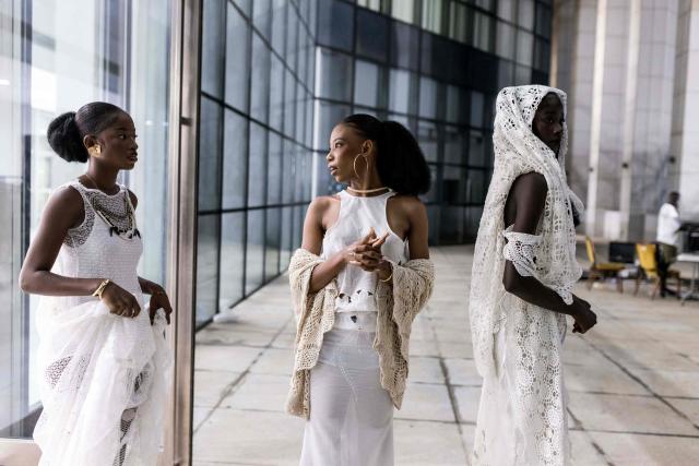 Models wait to walk the catwalk backstage during The Gambia International Fashion Week at Sir Dawda Kairaba Jawara International Conference Centre in Banjul on November 15, 2025. (Photo by Muhamadou BITTAYE / AFP)