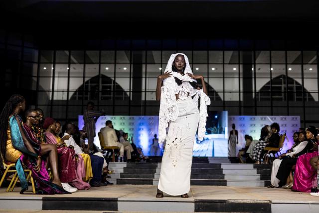 A model walks the catwalk during The Gambia International Fashion Week at Sir Dawda Kairaba Jawara International Conference Centre in Banjul on November 15, 2025. (Photo by Muhamadou BITTAYE / AFP)