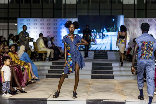 A model walks the catwalk during The Gambia International Fashion Week at Sir Dawda Kairaba Jawara International Conference Centre in Banjul on November 15, 2025. (Photo by Muhamadou BITTAYE / AFP)