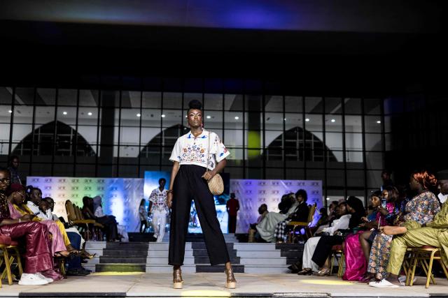A model walks the catwalk during The Gambia International Fashion Week at Sir Dawda Kairaba Jawara International Conference Centre in Banjul on November 15, 2025. (Photo by Muhamadou BITTAYE / AFP)