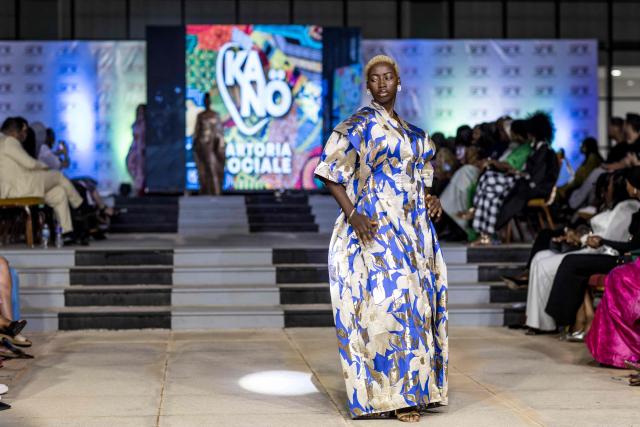 A model walks the catwalk during The Gambia International Fashion Week at Sir Dawda Kairaba Jawara International Conference Centre in Banjul on November 15, 2025. (Photo by Muhamadou BITTAYE / AFP)