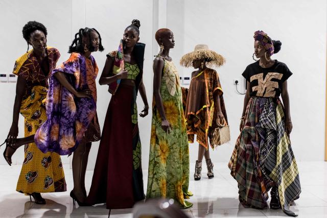 TOPSHOT - Models wait to walk the catwalk backstage during The Gambia International Fashion Week at Sir Dawda Kairaba Jawara International Conference Centre in Banjul on November 15, 2025. (Photo by Muhamadou BITTAYE / AFP)