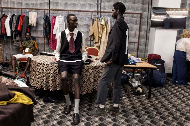 Models get ready backstage during The Gambia International Fashion Week at Sir Dawda Kairaba Jawara International Conference Centre in Banjul on November 15, 2025. (Photo by Muhamadou BITTAYE / AFP)