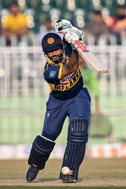 Sri Lanka's captain Kusal Mendis plays a shot during the third one-day international (ODI) cricket match between Pakistan and Sri Lanka at the Rawalpindi Cricket Stadium in Rawalpindi on November 16, 2025. (Photo by Aamir QURESHI / AFP)