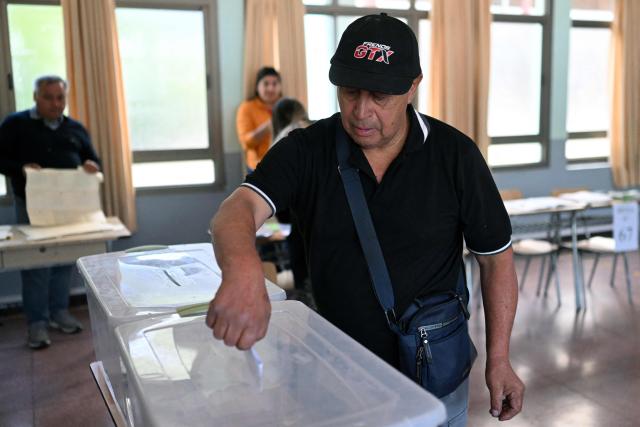 A man casts his vote during the general election, in Paine, south of Santiago, on November 16, 2025. Chileans are voting in a presidential election shaped by rising concerns over violent crime, with candidates pledging tougher measures against transnational gangs and the far-right promising to carry out mass migrant deportations. (Photo by MARVIN RECINOS / AFP)