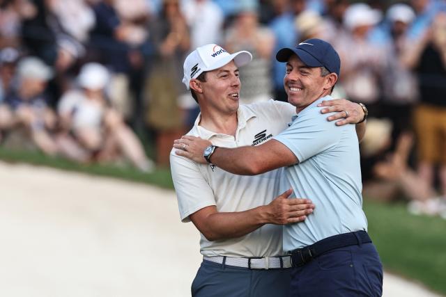 England's Matt Fitzpatrick (L) and Northern Ireland's Rory McIlroy celebrate at the end the 2025 DP World Tour Championship at Jumeirah Golf Estates in Dubai on November 16, 2025. Rory McIlroy was crowned the DP World Tour’s Race to Dubai champion for a seventh year, and four seasons in a row, but the world No.2 lost the $10 million Tour Championship to England’s Matt Fitzpatrick in the first playoff hole when he found the water with his tee shot. (Photo by Fadel SENNA / AFP)