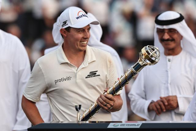TOPSHOT - England's Matt Fitzpatrick celebrates with his trophy at the end the 2025 DP World Tour Championship at Jumeirah Golf Estates in Dubai on November 16, 2025. Rory McIlroy was crowned the DP World Tour’s Race to Dubai champion for a seventh year, and four seasons in a row, but the world No.2 lost the $10 million Tour Championship to England’s Matt Fitzpatrick in the first playoff hole when he found the water with his tee shot. (Photo by Fadel SENNA / AFP)
