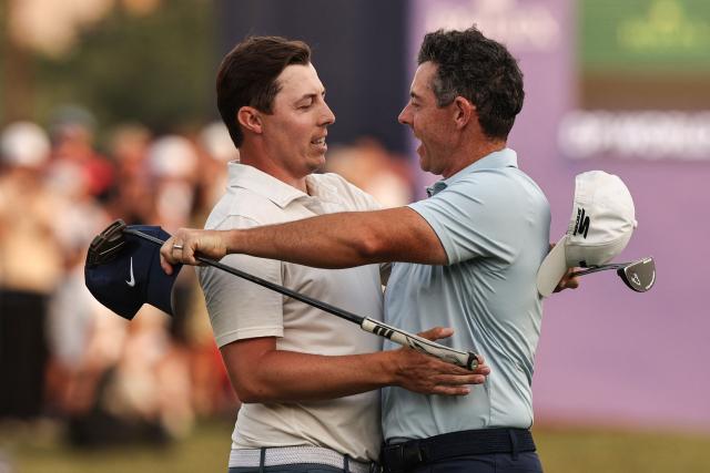 England's Matt Fitzpatrick (L) and Northern Ireland's Rory McIlroy celebrate at the end the 2025 DP World Tour Championship at Jumeirah Golf Estates in Dubai on November 16, 2025. Rory McIlroy was crowned the DP World Tour’s Race to Dubai champion for a seventh year, and four seasons in a row, but the world No.2 lost the $10 million Tour Championship to England’s Matt Fitzpatrick in the first playoff hole when he found the water with his tee shot. (Photo by Fadel SENNA / AFP)