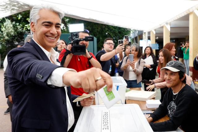 Chile's presidential candidate Marco Enriquez-Ominami, of the Progressive Party, smiles before casting his vote during the general election in Santiago on November 16, 2025. Chileans are voting in a presidential election shaped by rising concerns over violent crime, with candidates pledging tougher measures against transnational gangs and the far-right promising to carry out mass migrant deportations. (Photo by Raul BRAVO / AFP)