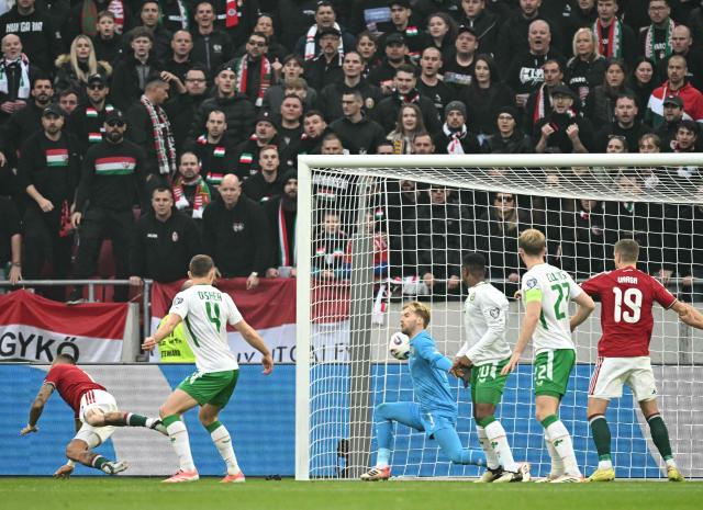 Hungary's forward #16 Daniel Lukacs (L) scores the 1-0 during the FIFA World Cup 2026 Group F European qualification football match betweem Hungary and Republic of Ireland at the Puskas Arena in Budapest, Hungary on Novemeber 16, 2025. (Photo by Attila KISBENEDEK / AFP)