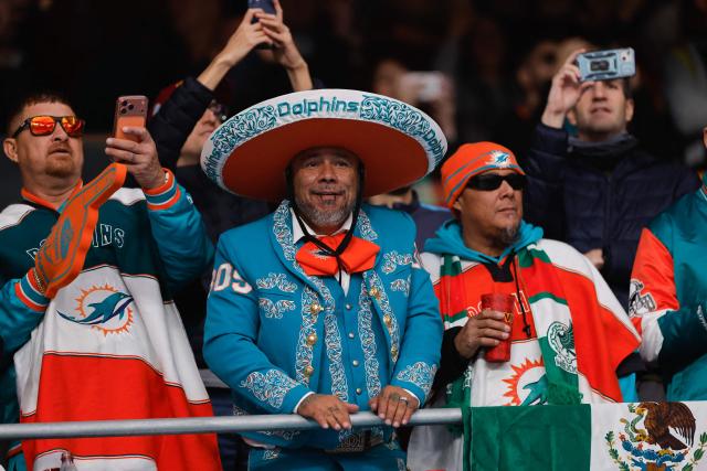 Miami dolphin supporters attend the NFL match between Miami Dolphins and Washington Commanders at Santiago Bernabeu Stadium in Madrid on November 16, 2025. (Photo by Oscar DEL POZO / AFP)