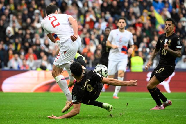 Armenia's defender #02 Sergei Muradian (TOP) and Portugal's forward #09 Goncalo Ramos fight for the ball during the 2026 World Cup qualifiers Europe zone group F football match between Portugal and Armenia, at Dragao stadium in Porto on November 16, 2025. (Photo by Miguel RIOPA / AFP)