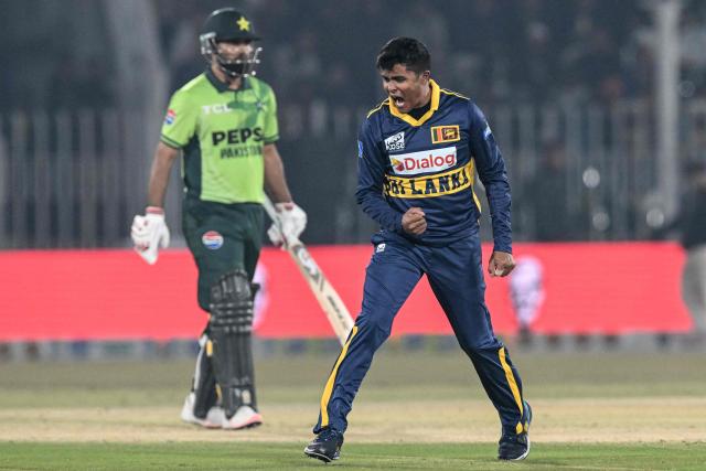 Sri Lanka's Jeffrey Vandersay (R) celebrates after taking the wicket of Pakistan's Fakhar Zaman (L) during the third one-day international (ODI) cricket match between Pakistan and Sri Lanka at the Rawalpindi Cricket Stadium in Rawalpindi on November 16, 2025. (Photo by Aamir QURESHI / AFP)