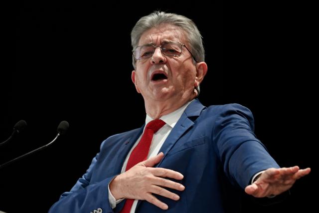 Founder of French left-wing party La France Insoumise (LFI) Jean-Luc Melenchon gestures as he gives a speech during a LFI meeting in Saint-Pierre-des-Corps, central France, on November 16, 2025. (Photo by JEAN-FRANCOIS MONIER / AFP)