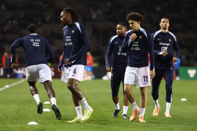 France's players, including midfielder #06 Khephren Thuram and forward #12 Maghnes Akliouche, warm up prior to the FIFA World Cup 2026 European qualification football match between Azerbaijan and France at the Tofiq Bahramov Republican Stadium in Baku on November 16, 2025. (Photo by FRANCK FIFE / AFP)