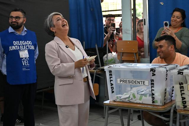 Chile's presidential candidate Jeannette Jara, of the Unidad por Chile coalition, laughs before casting her vote during the general election in Santiago on November 16, 2025. Chileans are voting in a presidential election shaped by rising concerns over violent crime, with candidates pledging tougher measures against transnational gangs and the far-right promising to carry out mass migrant deportations. (Photo by RODRIGO ARANGUA / AFP)