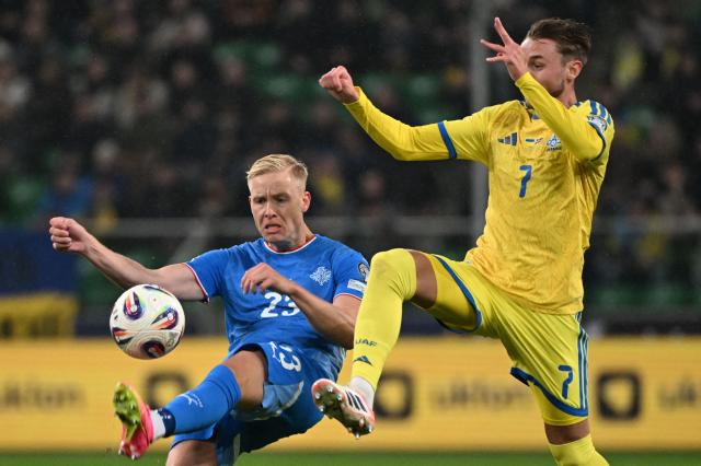Iceland's defender #23 Hordur Magnusson and Ukraine's forward #07 Vladyslav Vanat vie for the ball during the FIFA World Cup 2026 Group D European qualification football match betweem Ukraine and Iceland in Warsaw, Poland on Novmeber  16, 2025. (Photo by Sergei GAPON / AFP)