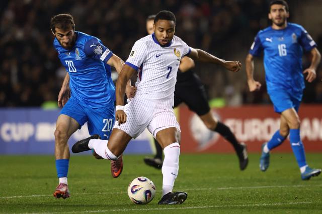Azerbaijan's midfielder #20 Abdulakh Khaybulaev and France's forward #07 Christopher Nkunku vie for the ball during the FIFA World Cup 2026 European qualification football match between Azerbaijan and France at the Tofiq Bahramov Republican Stadium in Baku on November 16, 2025. (Photo by FRANCK FIFE / AFP)