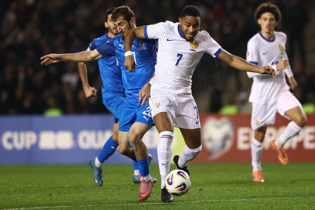 Azerbaijan's midfielder #20 Abdulakh Khaybulaev and France's forward #07 Christopher Nkunku vie for the ball during the FIFA World Cup 2026 European qualification football match between Azerbaijan and France at the Tofiq Bahramov Republican Stadium in Baku on November 16, 2025. (Photo by FRANCK FIFE / AFP)