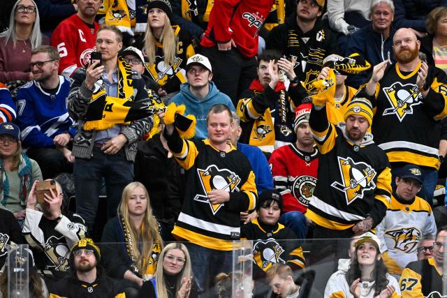 Penguins supporters cheer during the NHL Global Series Sweden ice hockey match between the Nashville Predators and the Pittsburgh Penguins at the Avicii Arena in Stockholm, Sweden, on November 16, 2025.  (Photo by Claudio BRESCIANI / TT NEWS AGENCY / AFP) / Sweden OUT