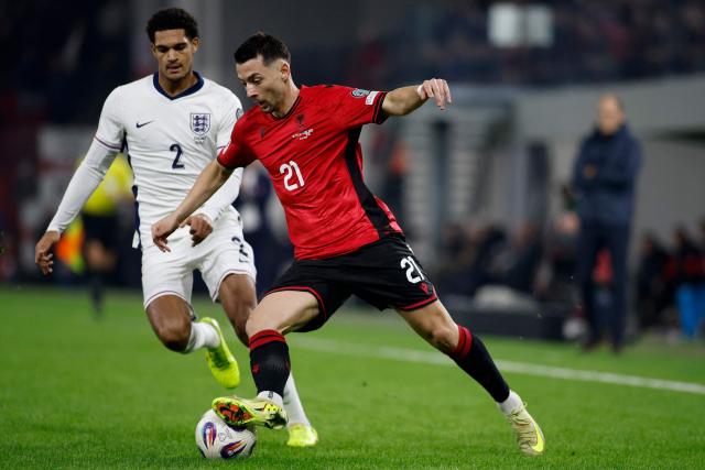 Albania's midfielder #21 Arber Hoxha controls the ball in front of England's defender #02 Jarell Quansah during the FIFA World Cup 2026 European qualification football match between Albania and England at the Air Albania stadium in Tirana, on November 16, 2025. (Photo by Adnan Beci / AFP)