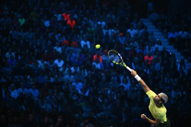Spain's Carlos Alcaraz hits a return to Italy's Jannik Sinner during the men's single final match at the ATP Finals tennis tournament, in Turin, on November 16, 2025. (Photo by Marco BERTORELLO / AFP)