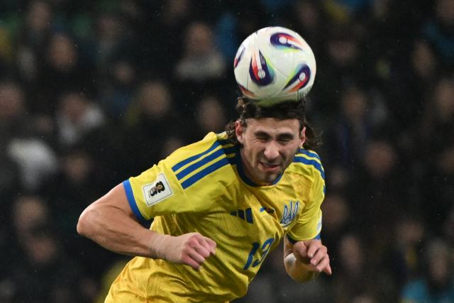 Ukraine's defender #13 Illia Zabarnyi heads the ball during the FIFA World Cup 2026 Group D European qualification football match betweem Ukraine and Iceland in Warsaw, Poland on Novmeber 16, 2025. (Photo by Sergei GAPON / AFP)