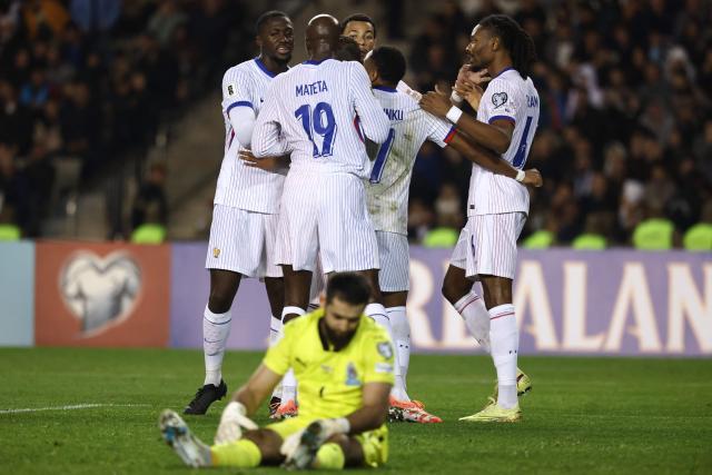 France's midfielder #06 Khephren Thuram celebrates with teammates after scoring the team's third goal during the FIFA World Cup 2026 European qualification football match between Azerbaijan and France at the Tofiq Bahramov Republican Stadium in Baku on November 16, 2025. (Photo by FRANCK FIFE / AFP)