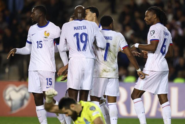 France's midfielder #06 Khephren Thuram celebrates with teammates after scoring the team's third goal during the FIFA World Cup 2026 European qualification football match between Azerbaijan and France at the Tofiq Bahramov Republican Stadium in Baku on November 16, 2025. (Photo by FRANCK FIFE / AFP)