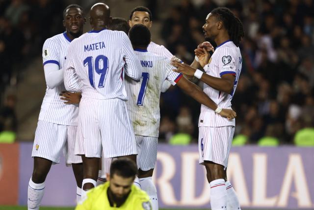 France's midfielder #06 Khephren Thuram celebrates with teammates after scoring the team's third goal during the FIFA World Cup 2026 European qualification football match between Azerbaijan and France at the Tofiq Bahramov Republican Stadium in Baku on November 16, 2025. (Photo by FRANCK FIFE / AFP)