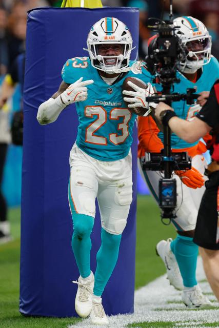 Miami Dolphins' cornerback #23 Jack Jones celebrates intercepting a pass thrown by Washington Commanders' quarterback #08 Marcus Mariota  during overtime in the NFL match between Miami Dolphins and Washington Commanders at Santiago Bernabeu Stadium in Madrid on November 16, 2025. (Photo by Oscar DEL POZO / AFP)