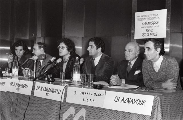 (FILES) French singer of Armenian origin Charles Aznavour (R) participates in the press conference of the organizers of the "march for survival in Cambodia", in the company of the philosopher Bernard-Henri Levy (L), the doctor Claude Malhuret (2ndL), the doctor Rony Brauman, member of Doctors Without Borders (Medecins Sans Frontieres, MSF), the doctor Xavier Emmanuelli of MSF and Jean Pierre-Bloch president of the Licra, in Paris on January 14, 1980. Xavier Emmanuelli, founder and honorary president of Samu social, died at the age of 87 on November 16, 2025, in Paris after a "probably cardiac" collapse, the organization announced, expressing its "sorrow" to AFP. (Photo by MICHEL CLEMENT / AFP)