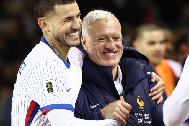 France's defender #21 Lucas Hernandez and France's head coach Didier Deschamps celebrate after the FIFA World Cup 2026 European qualification football match between Azerbaijan and France at the Tofiq Bahramov Republican Stadium in Baku on November 16, 2025. (Photo by FRANCK FIFE / AFP)