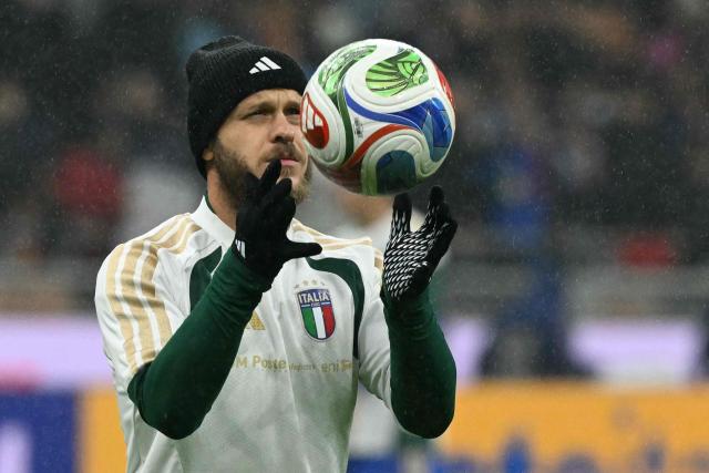 Italy's defender #03 Federico Dimarco warms up before the FIFA World Cup 2026 European qualification football match between Italy and Norway, at the San Siro Stadium, in Milan, on November 16, 2025. (Photo by Stefano RELLANDINI / AFP)