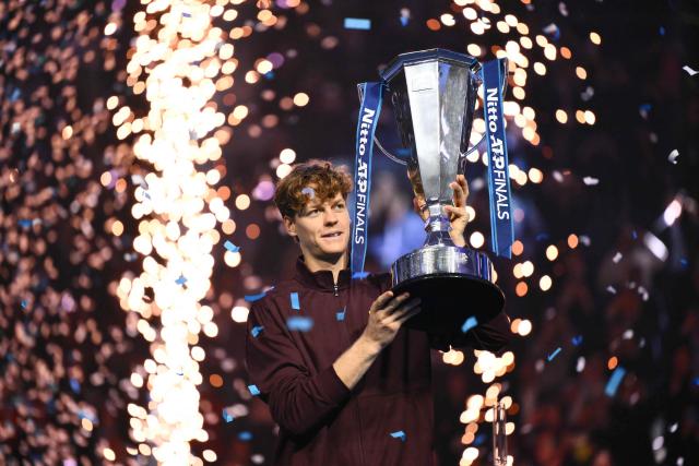 Italy's Jannik Sinner lifts the trophy after winning over Spain's Carlos Alcaraz at the end of the men's single final match at the ATP Finals tennis tournament, in Turin, on November 16, 2025. (Photo by Marco BERTORELLO / AFP)