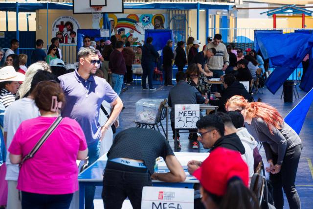 People queue to vote during Chile's general election at a polling station in Antofagasta, Chile on November 16, 2025. Chileans are voting in a presidential election shaped by rising concerns over violent crime, with candidates pledging tougher measures against transnational gangs and the far-right promising to carry out mass migrant deportations. (Photo by SEBASTIAN ROJAS ROJO / AFP)