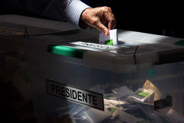 A person casts their vote during Chile's general election at a polling station in Antofagasta, Chile on November 16, 2025. Chileans are voting in a presidential election shaped by rising concerns over violent crime, with candidates pledging tougher measures against transnational gangs and the far-right promising to carry out mass migrant deportations. (Photo by SEBASTIAN ROJAS ROJO / AFP)