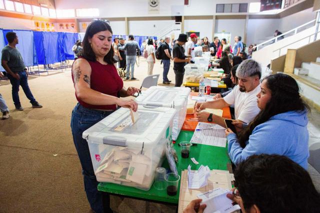 A woman casts her vote during Chile's general election at a polling station in Antofagasta, Chile on November 16, 2025. Chileans are voting in a presidential election shaped by rising concerns over violent crime, with candidates pledging tougher measures against transnational gangs and the far-right promising to carry out mass migrant deportations. (Photo by SEBASTIAN ROJAS ROJO / AFP)