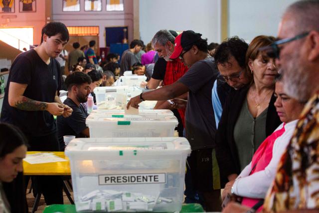 A man casts his vote during Chile's general election at a polling station in Antofagasta, Chile on November 16, 2025. Chileans are voting in a presidential election shaped by rising concerns over violent crime, with candidates pledging tougher measures against transnational gangs and the far-right promising to carry out mass migrant deportations. (Photo by SEBASTIAN ROJAS ROJO / AFP)