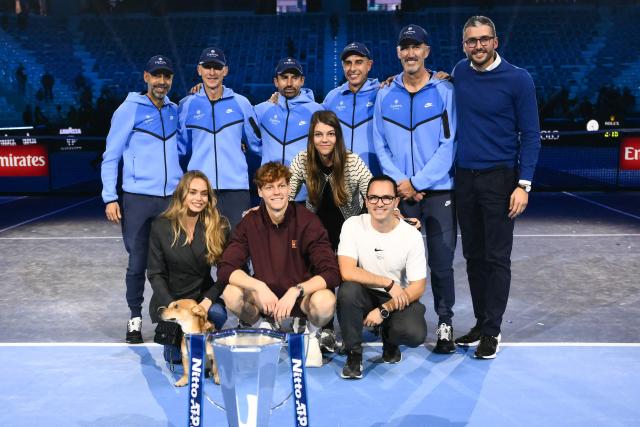 Italy's Jannik Sinner team members pose with Jannik Sinner (C, bottom) and his girldfriend Laila Hasanovic (L, bottom) at the end of the men's single final match at the ATP Finals tennis tournament, in Turin, on November 16, 2025. (Photo by Marco BERTORELLO / AFP)