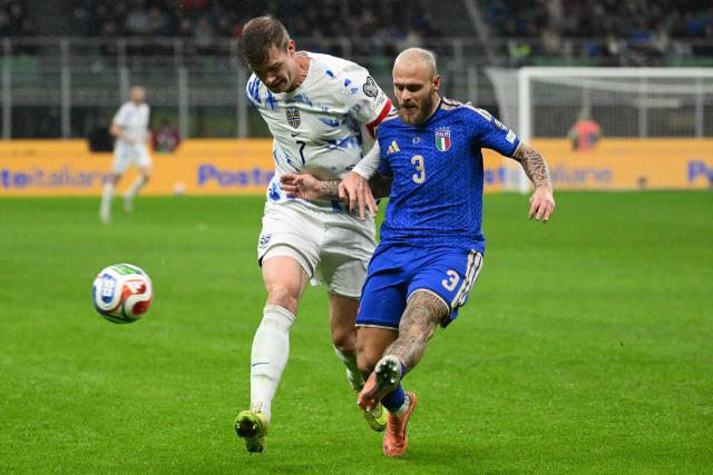 Norway's forward  #07 Alexander Sorloth fights for the ball with Italy's defender #03 Federico Dimarco during the FIFA World Cup 2026 European qualification football match between Italy and Norway, at the San Siro Stadium, in Milan, on November 16, 2025. (Photo by Alberto PIZZOLI / AFP)