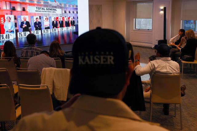 Supporters of Chile's presidential candidate Johannes Kaiser, of the Libertarian National Party, react after the first exit poll results of the general election in Santiago on November 16, 2025. (Photo by Raul BRAVO / AFP)